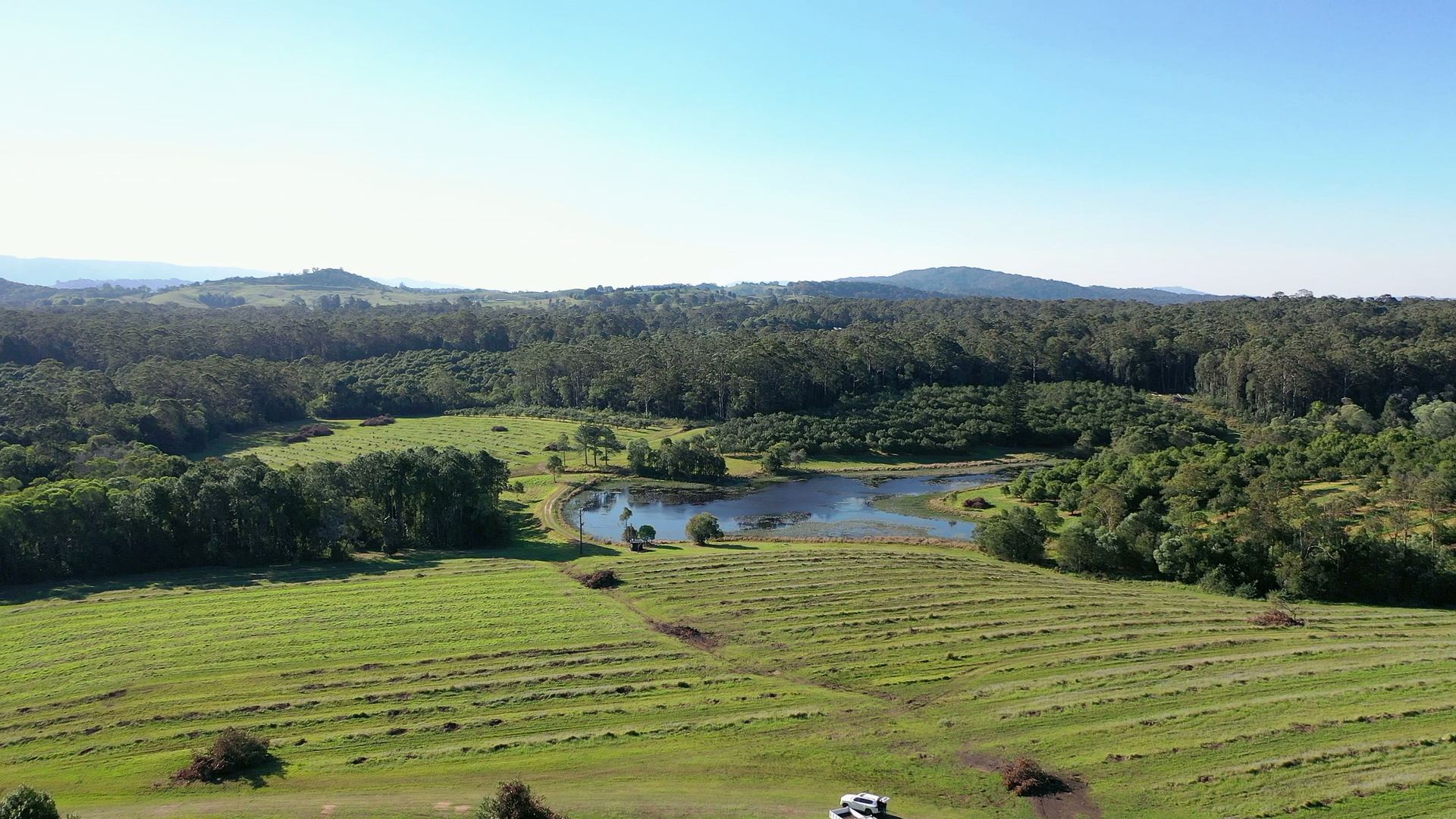 Wide view over hinterland ranges and farmland from above the estate