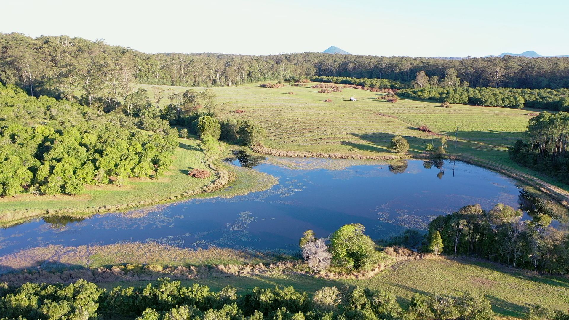 Still reflections on the lake at La Boscosa Estate with the hinterland ranges beyond